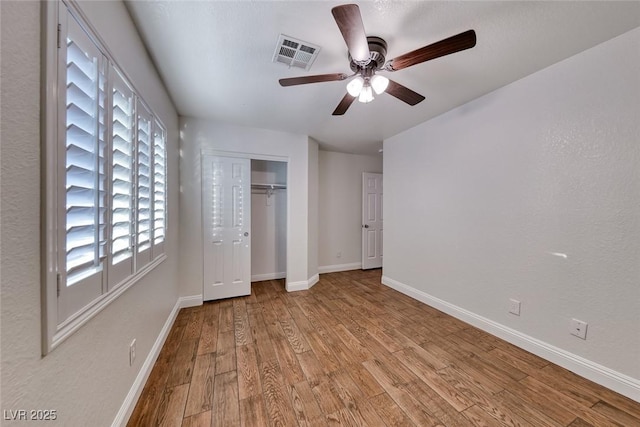 1643 Silver Slipper Ave, Henderson, NV 89002 - unfurnished bedroom with wood finished floors, a closet, and a ceiling fan