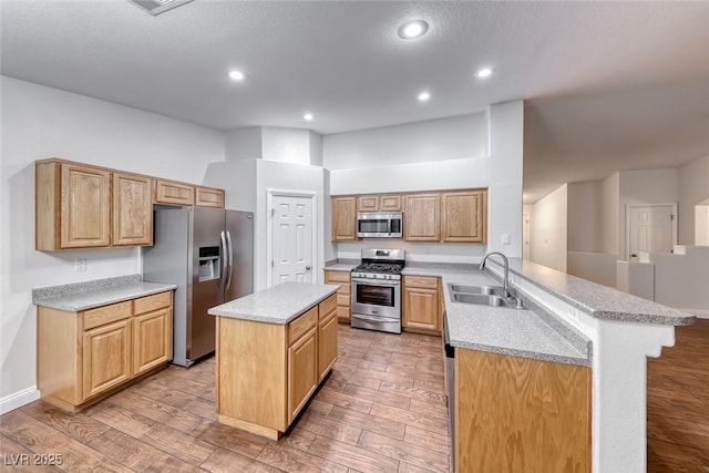1643 Silver Slipper Ave, Henderson, NV 89002 - kitchen featuring stainless steel appliances, a peninsula, a center island, light wood-style flooring, and recessed lighting