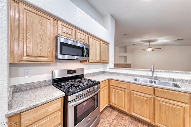 1643 Silver Slipper Ave, Henderson, NV 89002 - kitchen with appliances with stainless steel finishes, light brown cabinets, light wood finished floors, light countertops, and a ceiling fan