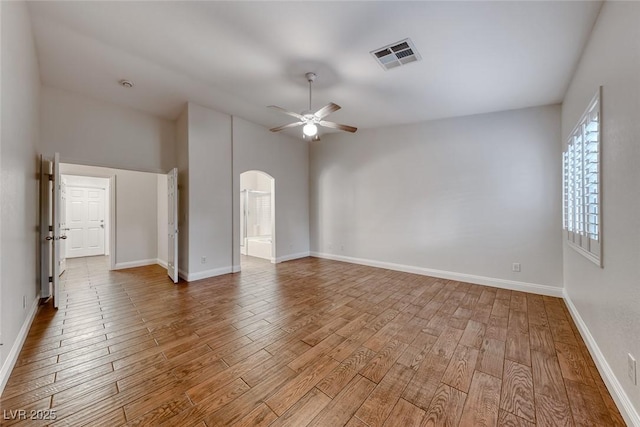 1643 Silver Slipper Ave, Henderson, NV 89002 - unfurnished room featuring a ceiling fan, arched walkways, wood finished floors, and vaulted ceiling