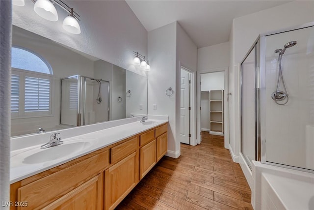 1643 Silver Slipper Ave, Henderson, NV 89002 - full bathroom featuring a stall shower, wood finished floors, double vanity, and a tub to relax in
