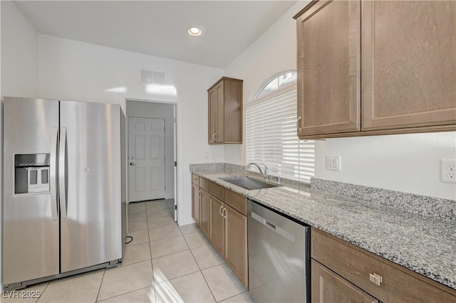 7775 Tyrell Peaks St, Las Vegas, NV 89139 - kitchen with appliances with stainless steel finishes, light stone counters, light tile patterned floors, and recessed lighting
