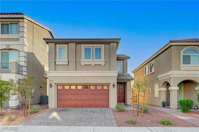7775 Tyrell Peaks St, Las Vegas, NV 89139 - view of front facade with stucco siding, a garage, and driveway
