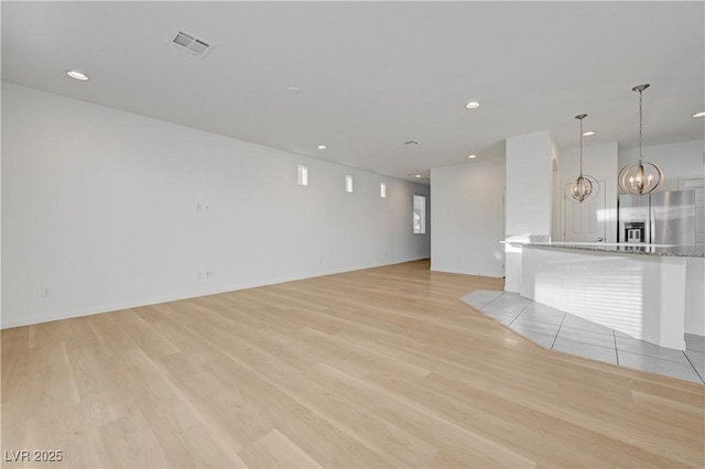 7775 Tyrell Peaks St, Las Vegas, NV 89139 - unfurnished living room featuring light wood-style flooring, a chandelier, and recessed lighting