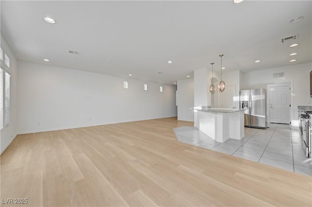 7775 Tyrell Peaks St, Las Vegas, NV 89139 - unfurnished living room featuring light wood-style flooring and recessed lighting