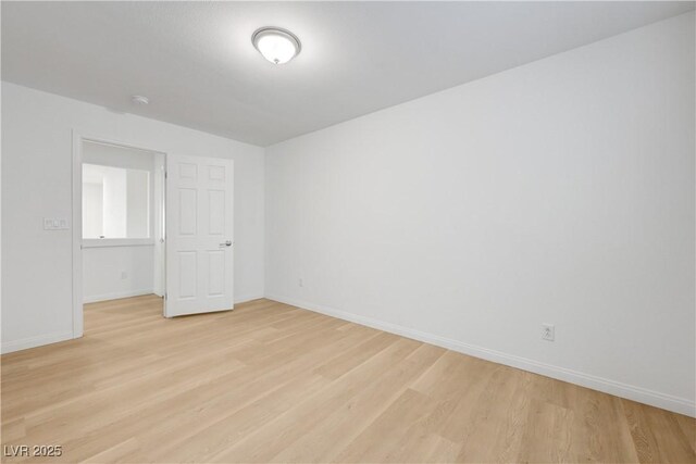 7775 Tyrell Peaks St, Las Vegas, NV 89139 - empty room with light wood-type flooring and a smoke detector