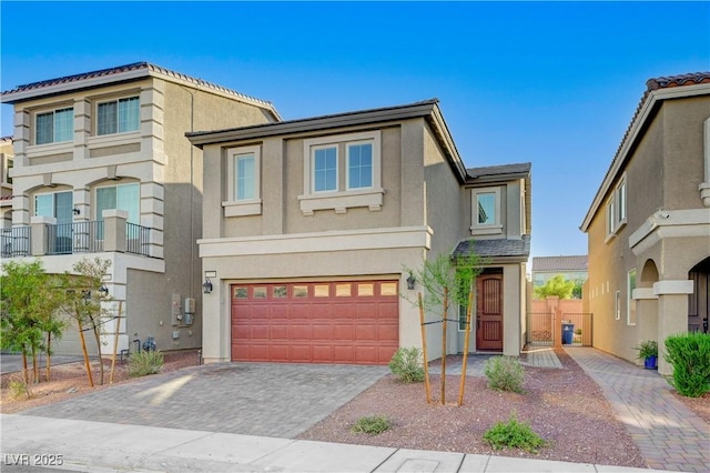 7775 Tyrell Peaks St, Las Vegas, NV 89139 - view of front of home featuring an attached garage, stucco siding, and decorative driveway