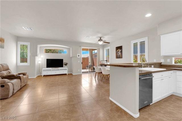 11139 Zarod Rd, Las Vegas, NV 89135 - kitchen featuring dishwasher, open floor plan, a peninsula, dark countertops, and a ceiling fan