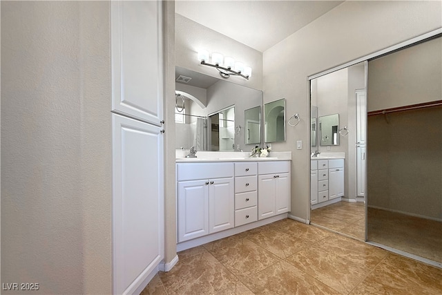 11139 Zarod Rd, Las Vegas, NV 89135 - full bath with double vanity, a walk in closet, and tile patterned flooring
