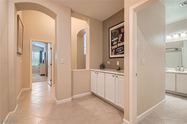 7559 Chambery Cove Ct, Las Vegas, NV 89123 - hallway with arched walkways and light tile patterned flooring