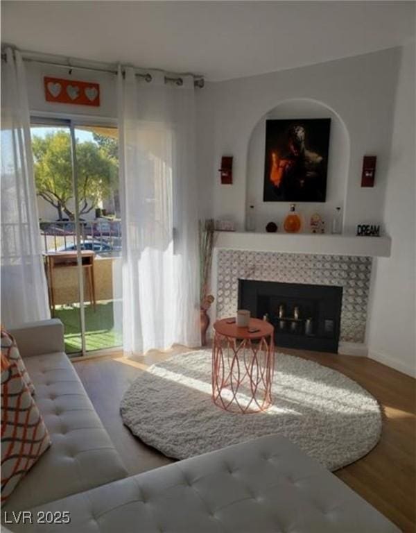 7885 W Flamingo Rd Unit 2129, Las Vegas, NV 89147 - living room featuring wood finished floors and a tile fireplace