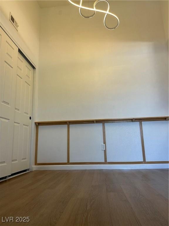 7885 W Flamingo Rd Unit 2129, Las Vegas, NV 89147 - unfurnished room featuring wood finished floors and a chandelier