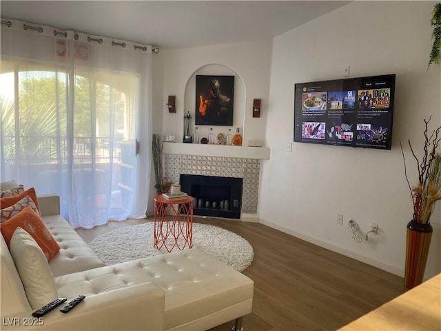 7885 W Flamingo Rd Unit 2129, Las Vegas, NV 89147 - living room featuring wood finished floors and a tiled fireplace
