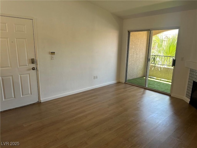 7885 W Flamingo Rd Unit 2129, Las Vegas, NV 89147 - empty room with a fireplace and wood finished floors