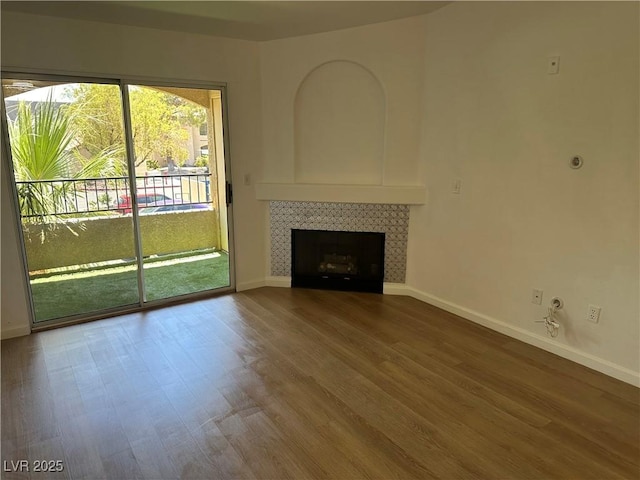 7885 W Flamingo Rd Unit 2129, Las Vegas, NV 89147 - unfurnished living room with wood finished floors and a fireplace