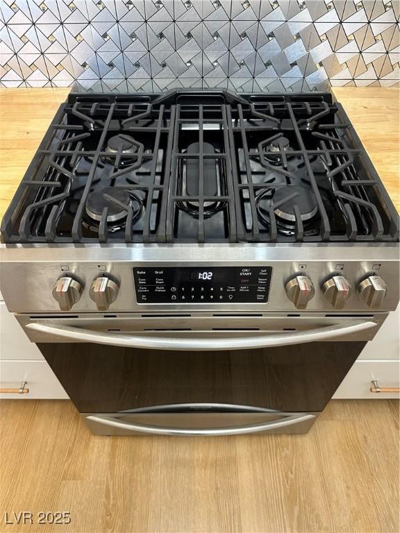 7885 W Flamingo Rd Unit 2129, Las Vegas, NV 89147 - kitchen view of stainless steel gas range and wood finished floors