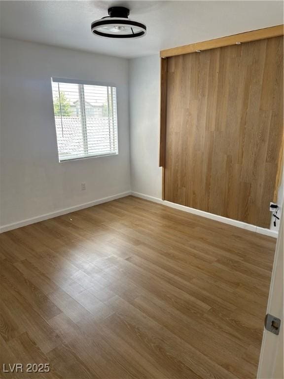 7885 W Flamingo Rd Unit 2129, Las Vegas, NV 89147 - empty room with wood finished floors and baseboards