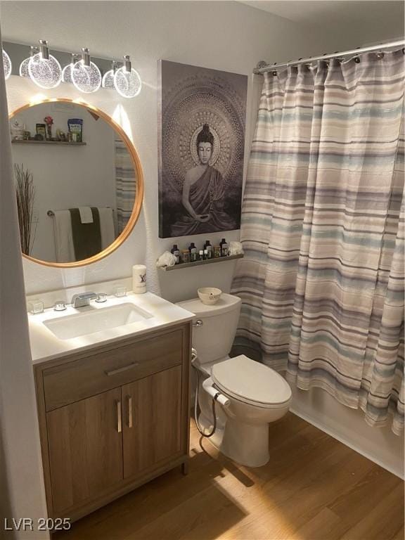 7885 W Flamingo Rd Unit 2129, Las Vegas, NV 89147 - bathroom with wood finished floors, vanity, and shower / tub combo with curtain