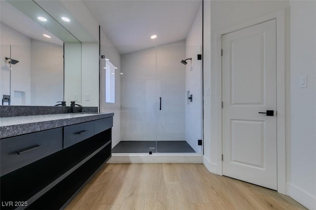 7132 Mission Hills Dr, Las Vegas, NV 89113 - full bathroom with a stall shower, vanity, wood finished floors, and recessed lighting