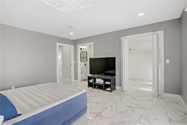 4490 W Warm Springs Rd, Las Vegas, NV 89118 - bedroom with a spacious closet, light marble finish floors, recessed lighting, a closet, and ensuite bathroom