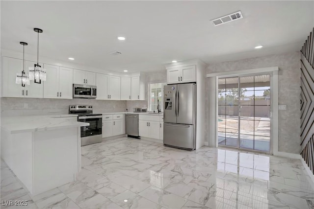 4490 W Warm Springs Rd, Las Vegas, NV 89118 - kitchen featuring appliances with stainless steel finishes, healthy amount of natural light, white cabinetry, recessed lighting, and light stone counters