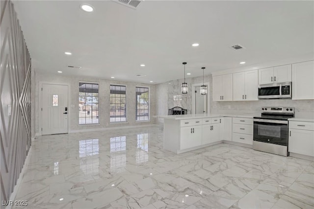 4490 W Warm Springs Rd, Las Vegas, NV 89118 - kitchen featuring appliances with stainless steel finishes, open floor plan, a peninsula, recessed lighting, and white cabinets
