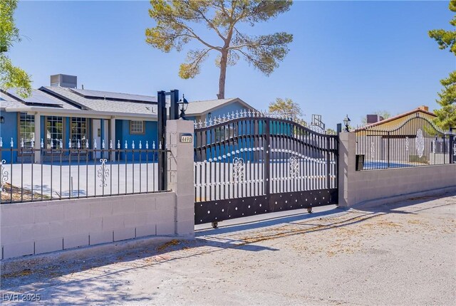 4490 W Warm Springs Rd, Las Vegas, NV 89118 - gate featuring a fenced front yard and solar panels