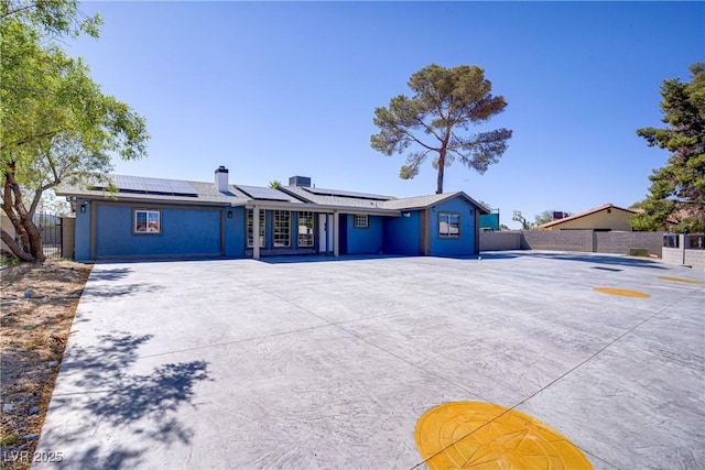 4490 W Warm Springs Rd, Las Vegas, NV 89118 - ranch-style house with roof mounted solar panels and a chimney