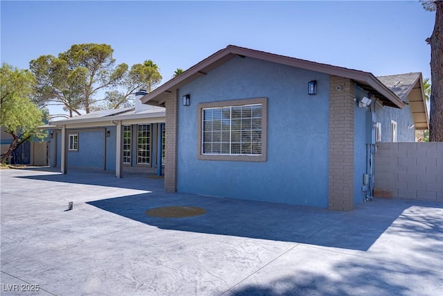 4490 W Warm Springs Rd, Las Vegas, NV 89118 - rear view of property featuring stucco siding
