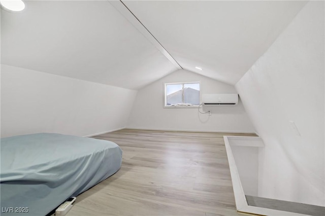 4490 W Warm Springs Rd, Las Vegas, NV 89118 - bedroom featuring a wall mounted AC, vaulted ceiling, and wood finished floors