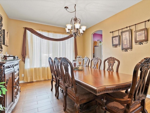 1870 Desert Forest Way, Henderson, NV 89012 - dining area featuring arched walkways, a chandelier, and wood finished floors