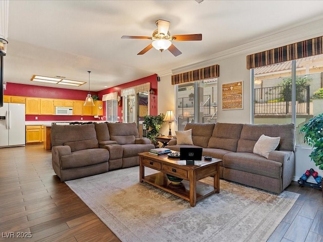 1870 Desert Forest Way, Henderson, NV 89012 - living room featuring ceiling fan, wood finished floors, and ornamental molding