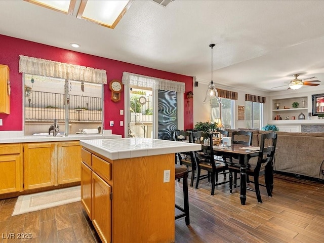 1870 Desert Forest Way, Henderson, NV 89012 - kitchen with tile counters, open floor plan, wood finished floors, a ceiling fan, and recessed lighting