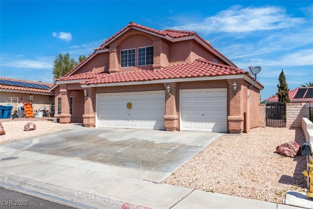 7720 Leavorite Dr, Las Vegas, NV 89128 - mediterranean / spanish-style home with concrete driveway, stucco siding, a tiled roof, and a garage