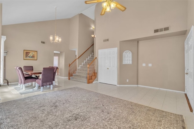 7720 Leavorite Dr, Las Vegas, NV 89128 - tiled entrance foyer with high vaulted ceiling, stairs, a chandelier, and a ceiling fan