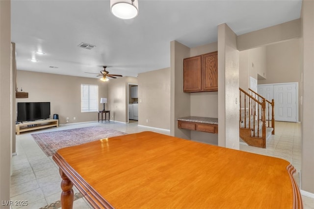 7720 Leavorite Dr, Las Vegas, NV 89128 - dining space with light tile patterned flooring, ceiling fan, and stairs