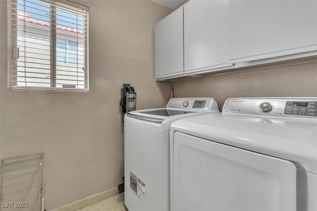 7720 Leavorite Dr, Las Vegas, NV 89128 - laundry room with cabinet space, washer and clothes dryer, light tile patterned floors, and a textured wall