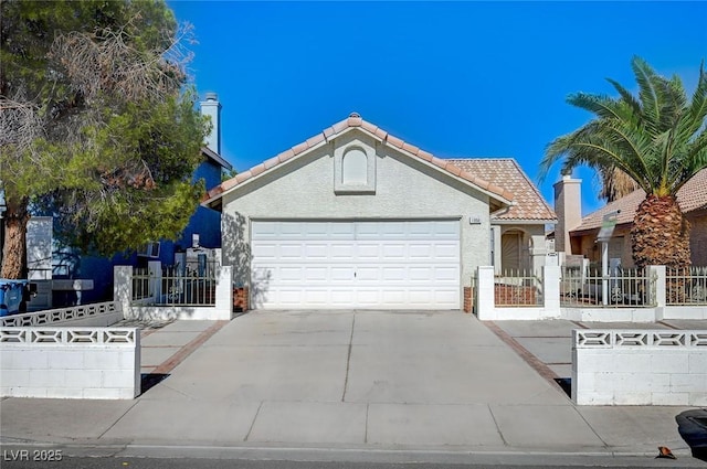 1950 Turtlerock St, Las Vegas, NV 89142 - ranch-style house with driveway, a tiled roof, an attached garage, and stucco siding