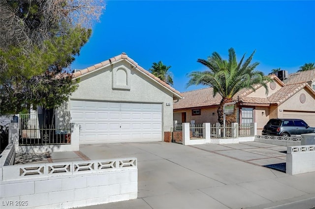 1950 Turtlerock St, Las Vegas, NV 89142 - ranch-style home featuring driveway, an attached garage, a tile roof, and stucco siding