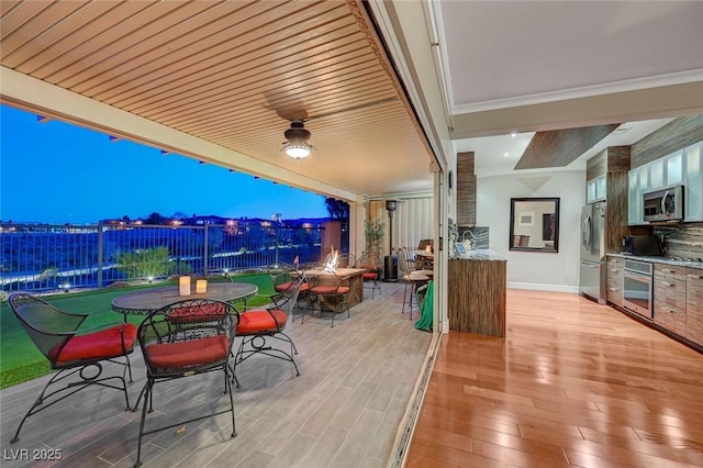 10621 Tinta Ln, Las Vegas, NV 89144 - view of patio featuring outdoor dining space, a ceiling fan, a wooden deck, and an outdoor kitchen