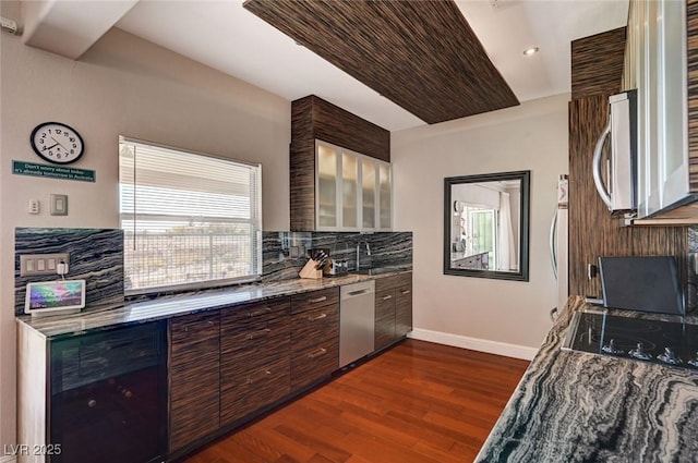 10621 Tinta Ln, Las Vegas, NV 89144 - kitchen with stainless steel appliances, dark wood finished floors, backsplash, light stone countertops, and recessed lighting