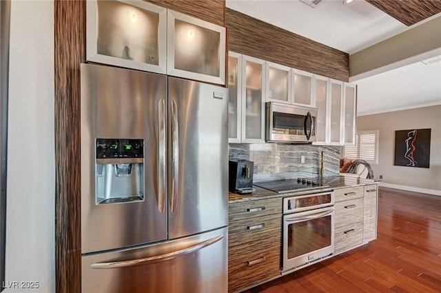 10621 Tinta Ln, Las Vegas, NV 89144 - kitchen with appliances with stainless steel finishes, dark wood-style floors, tasteful backsplash, white cabinetry, and light stone counters