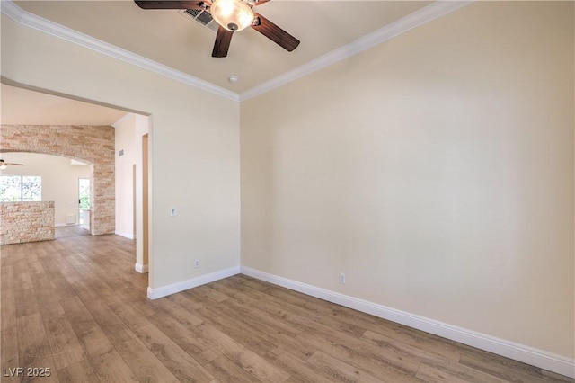 1869 Desert Forest Way, Henderson, NV 89012 - empty room featuring a ceiling fan, wood finished floors, crown molding, and arched walkways
