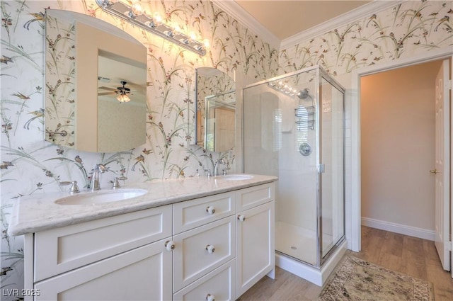 1869 Desert Forest Way, Henderson, NV 89012 - full bathroom featuring ornamental molding, wallpapered walls, wood finished floors, a shower stall, and double vanity
