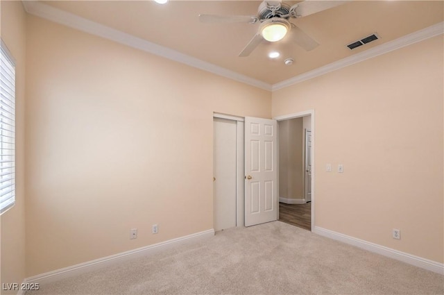1869 Desert Forest Way, Henderson, NV 89012 - unfurnished bedroom featuring crown molding, carpet, multiple windows, a closet, and ceiling fan