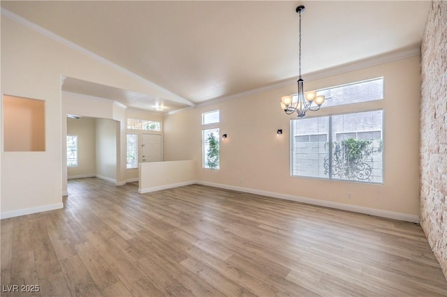 1869 Desert Forest Way, Henderson, NV 89012 - unfurnished room with a chandelier, crown molding, light wood-style flooring, vaulted ceiling, and healthy amount of natural light
