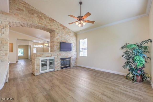 1869 Desert Forest Way, Henderson, NV 89012 - unfurnished living room with lofted ceiling, a ceiling fan, a glass covered fireplace, and wood finished floors