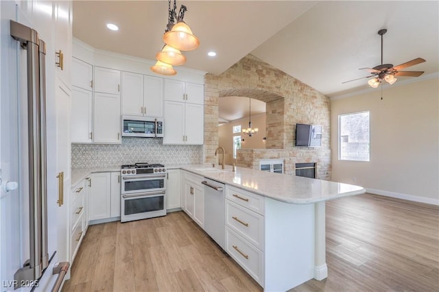 1869 Desert Forest Way, Henderson, NV 89012 - kitchen with appliances with stainless steel finishes, a peninsula, lofted ceiling, healthy amount of natural light, and ceiling fan