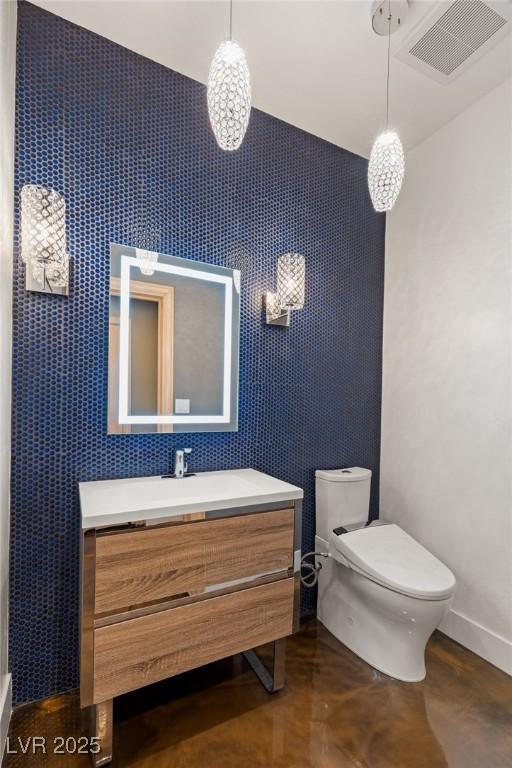 3004 Astoria Pines Cir, Las Vegas, NV 89107 - bathroom featuring vanity, concrete flooring, and an accent wall
