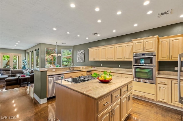 3004 Astoria Pines Cir, Las Vegas, NV 89107 - kitchen with appliances with stainless steel finishes, a center island, recessed lighting, open floor plan, and light brown cabinetry